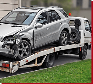 truck carrying a wrecked car