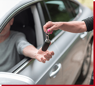 handing key to driver of a car
